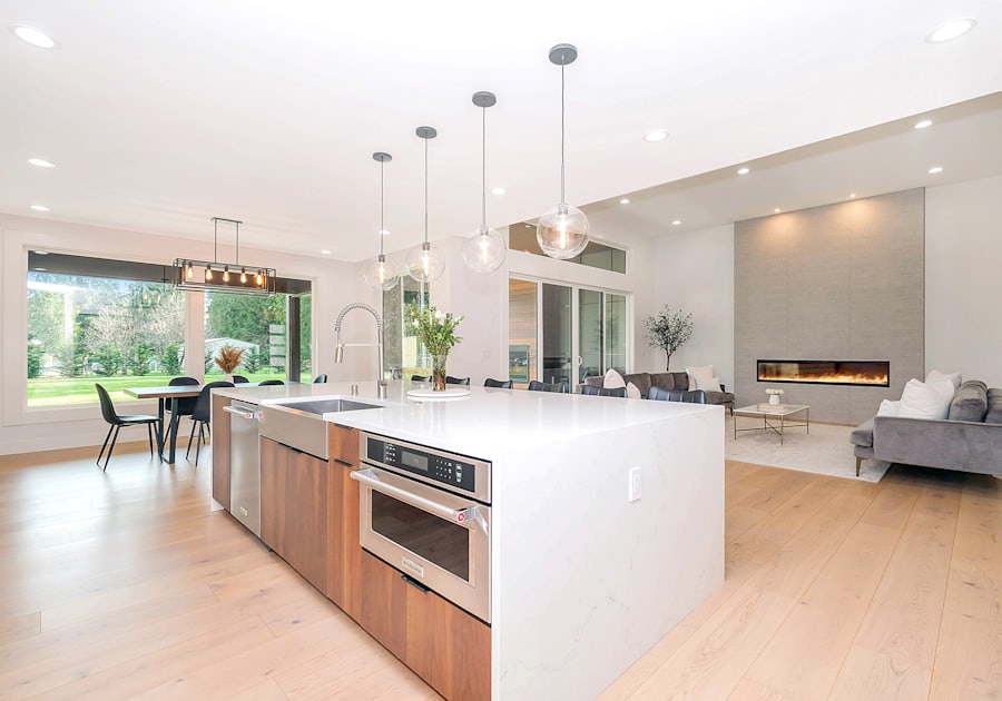 Bright remodeled kitchen with white cabinetry and wood accents